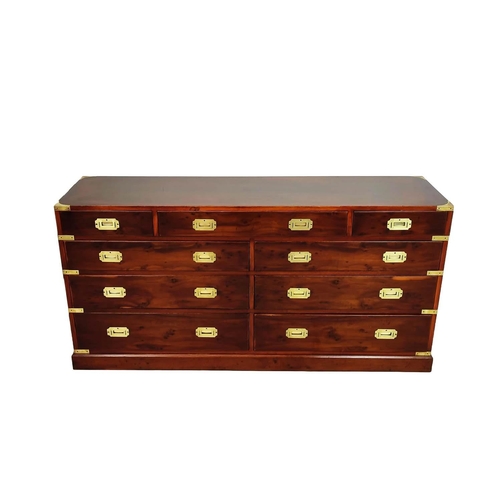 476 - CAMPAIGN STYLE BANK OF DRAWERS, yewwood and brass bound with nine drawers, 73cm H x 153cm x 44cm.