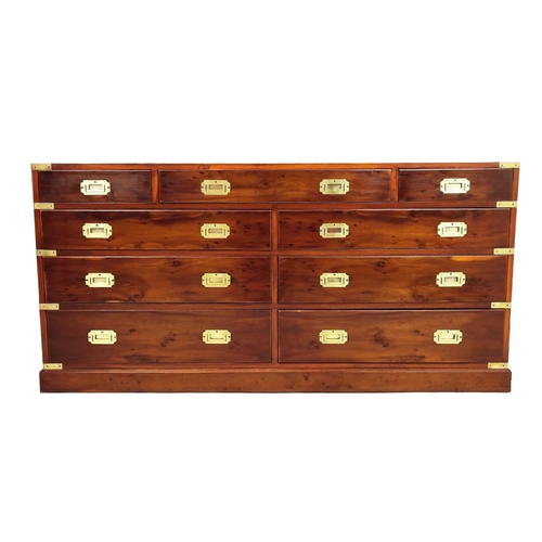 476 - CAMPAIGN STYLE BANK OF DRAWERS, yewwood and brass bound with nine drawers, 73cm H x 153cm x 44cm.