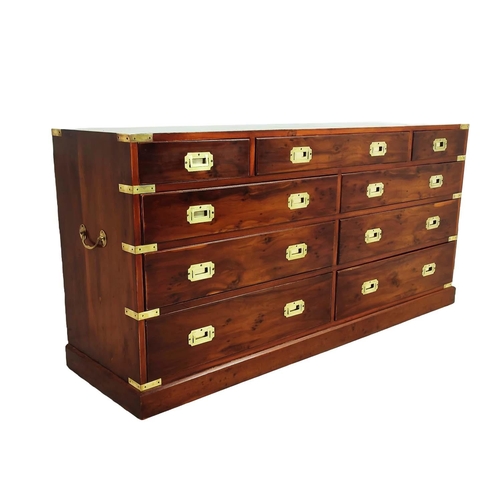 476 - CAMPAIGN STYLE BANK OF DRAWERS, yewwood and brass bound with nine drawers, 73cm H x 153cm x 44cm.