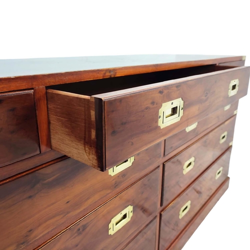 476 - CAMPAIGN STYLE BANK OF DRAWERS, yewwood and brass bound with nine drawers, 73cm H x 153cm x 44cm.