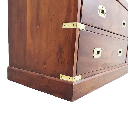 476 - CAMPAIGN STYLE BANK OF DRAWERS, yewwood and brass bound with nine drawers, 73cm H x 153cm x 44cm.