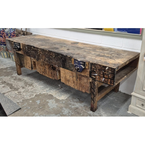 523 - WORKBENCH, 20th century pine with two fixed vices and three deep drawers, 89cm H x 305cm W x 89cm D.