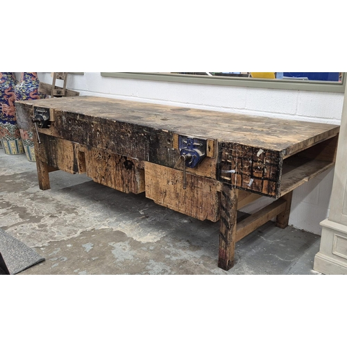 523 - WORKBENCH, 20th century pine with two fixed vices and three deep drawers, 89cm H x 305cm W x 89cm D.