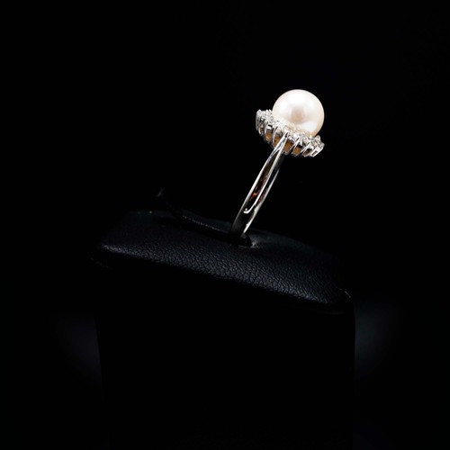 10 - A 9CT WHITE GOLD CULTURED PEARL AND DIAMOND HALO RING, boxed, the round brilliant cut diamonds of ap... 