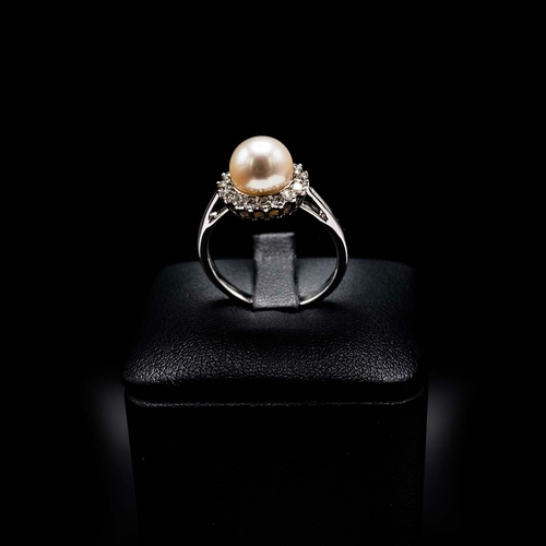 10 - A 9CT WHITE GOLD CULTURED PEARL AND DIAMOND HALO RING, boxed, the round brilliant cut diamonds of ap... 