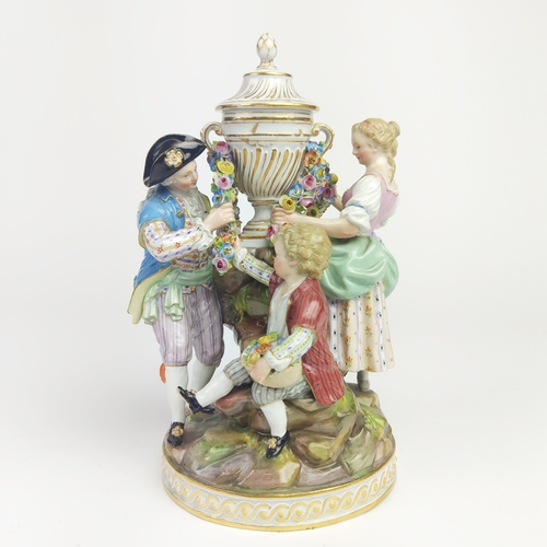 22 - MEISSEN FIGURE GROUP DEPICTING A LADY, gentleman and boy holding a chain, urn to centre, a Meissen f... 