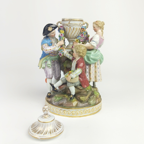 22 - MEISSEN FIGURE GROUP DEPICTING A LADY, gentleman and boy holding a chain, urn to centre, a Meissen f... 