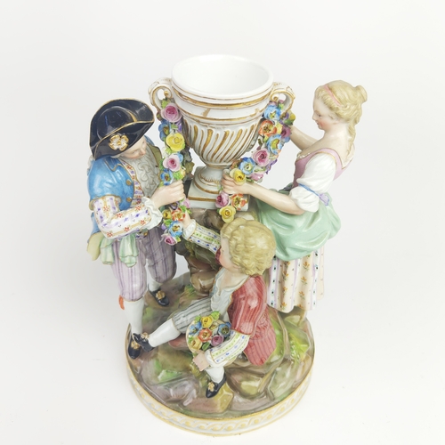 22 - MEISSEN FIGURE GROUP DEPICTING A LADY, gentleman and boy holding a chain, urn to centre, a Meissen f... 