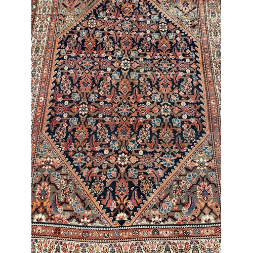 302 - ANTIQUE MALAYER RUG, 193cm x 137cm.