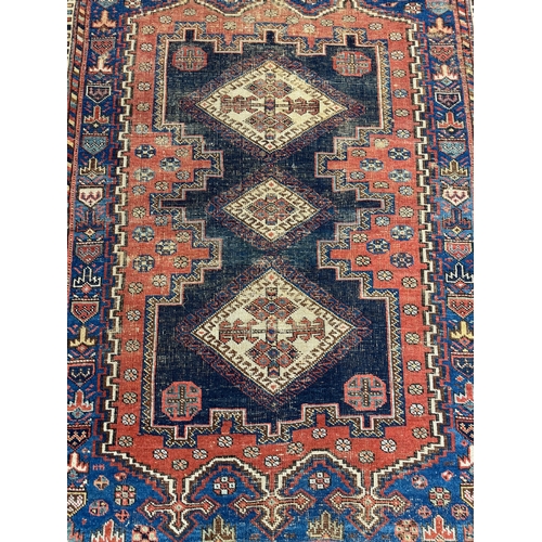 303 - ANTIQUE QASHQAI RUG, 175cm x 131cm.