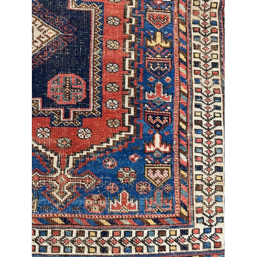 303 - ANTIQUE QASHQAI RUG, 175cm x 131cm.