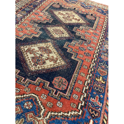 303 - ANTIQUE QASHQAI RUG, 175cm x 131cm.