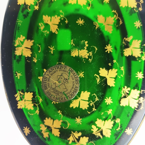 31 - BRISTOL EMERALD GLASS LIDDED CASKET, gold leaf motif decoration, oval form, twin handles, 10cm H.