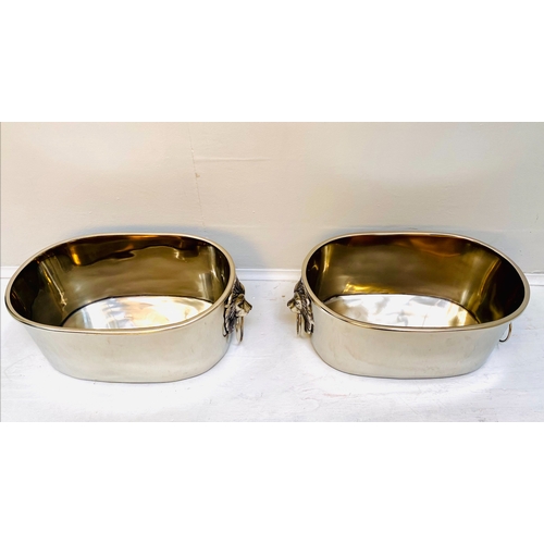 454 - CHAMPAGNE COOLERS, a pair, polished metal with lion head handles, 16cm H x 45cm x 26cm. (2)