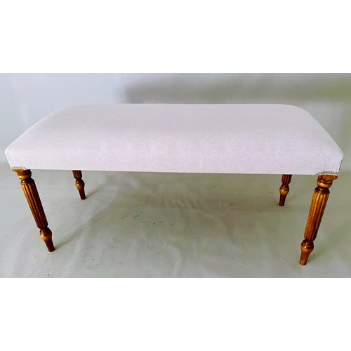 457 - FOOTSTOOL, neutral linen upholstery on reeded wooden supports.