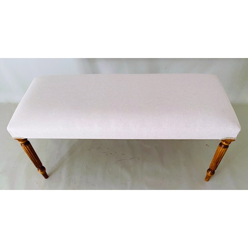 457 - FOOTSTOOL, neutral linen upholstery on reeded wooden supports.