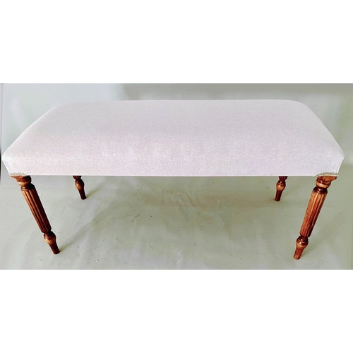 457 - FOOTSTOOL, neutral linen upholstery on reeded wooden supports.