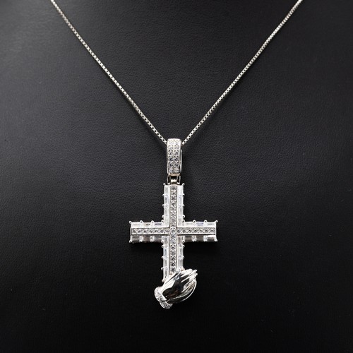 7 - A COLLECTION OF FOUR SILVER CHAINS including the following pendants: cross set with cubic zirconia, ... 