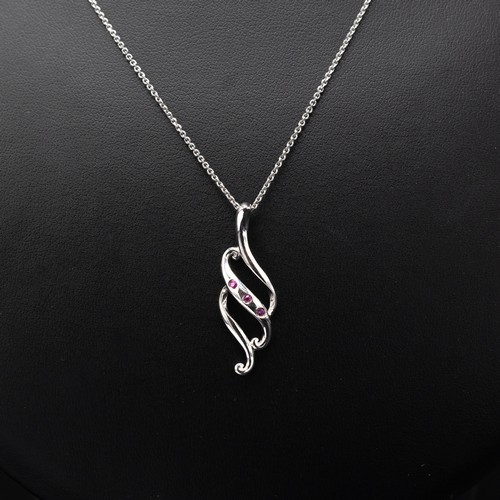 7 - A COLLECTION OF FOUR SILVER CHAINS including the following pendants: cross set with cubic zirconia, ... 