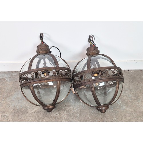 445 - A PAIR SPHERICAL HANGING LANTERN LIGHTS, with glazed bodies and pierced centres, 70cm H. (2)