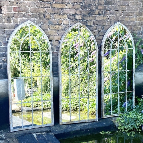 422 - GARDEN WALL MIRRORS, a set of three, metal arched frames, 160cm H x 67cm W. (3)