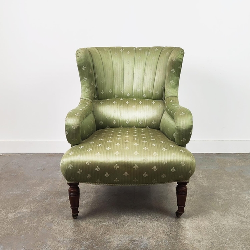 131 - WING ARMCHAIR, Victorian walnut in green fleur de lis upholstery on brass castors.