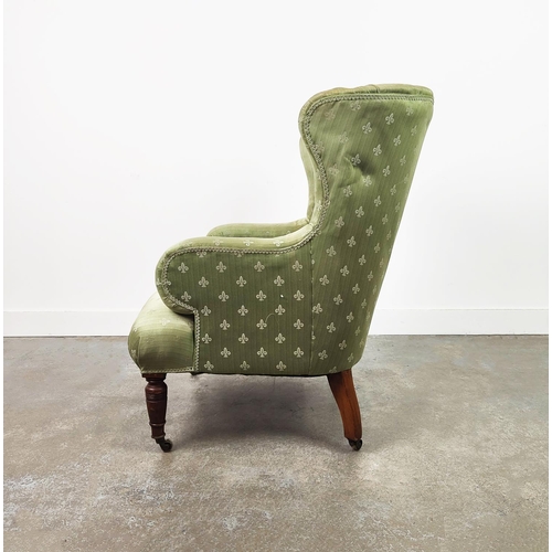 131 - WING ARMCHAIR, Victorian walnut in green fleur de lis upholstery on brass castors.