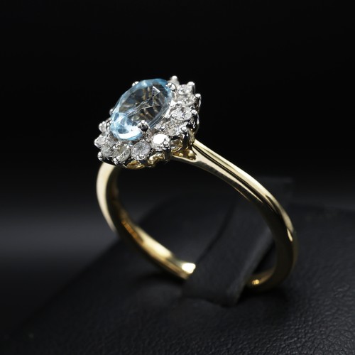 29 - 9ct yellow and white gold oval-cut blue topaz and RBC diamond cluster ring. Topaz 0.94ct. Diamonds 0... 