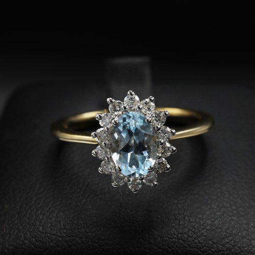 29 - 9ct yellow and white gold oval-cut blue topaz and RBC diamond cluster ring. Topaz 0.94ct. Diamonds 0... 