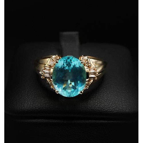 20 - 14ct yellow gold paraibe apatite and diamond dress ring. Oval-cut apatite 3.40ct. Baguette and round... 