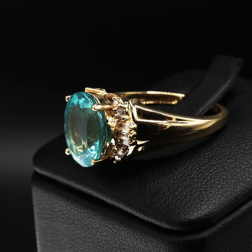 20 - 14ct yellow gold paraibe apatite and diamond dress ring. Oval-cut apatite 3.40ct. Baguette and round... 