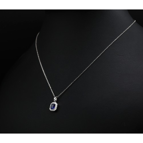 31 - 18ct white gold emerald cut sapphire and RBC diamond cluster pendant on an 18ct white gold chain, bo... 