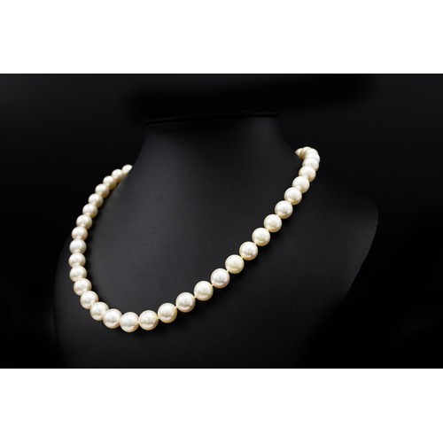 82 - A SINGLE STRAND CULTURED PEARL NECKLACE, having 45 individually knotted 10mm round pearls, fitted wi... 