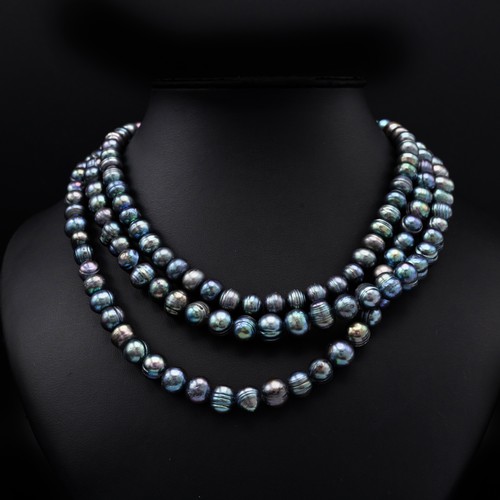 114 - A THREE STRAND FRESHWATER PEACOCK PEARL NECKLACE, each strand of graduated length, with a total of a... 