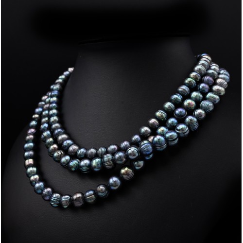 114 - A THREE STRAND FRESHWATER PEACOCK PEARL NECKLACE, each strand of graduated length, with a total of a... 