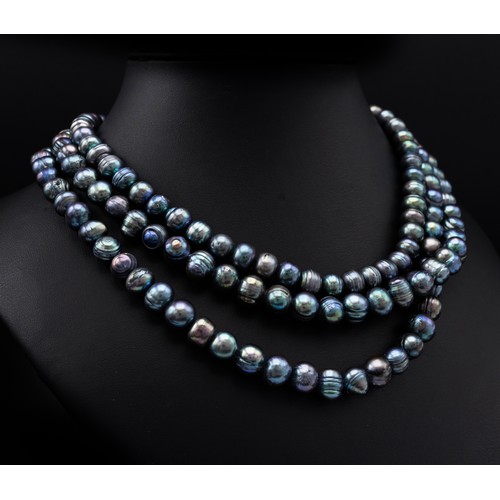 114 - A THREE STRAND FRESHWATER PEACOCK PEARL NECKLACE, each strand of graduated length, with a total of a... 