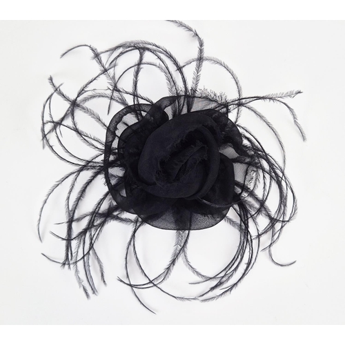 11 - CHANEL BROOCH, iconic black silk camellia with raw hem, ostrich feather at base, gold tone safety pi... 