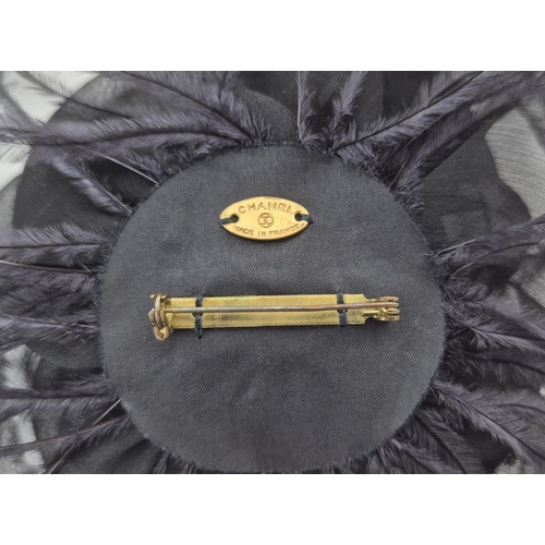 11 - CHANEL BROOCH, iconic black silk camellia with raw hem, ostrich feather at base, gold tone safety pi... 