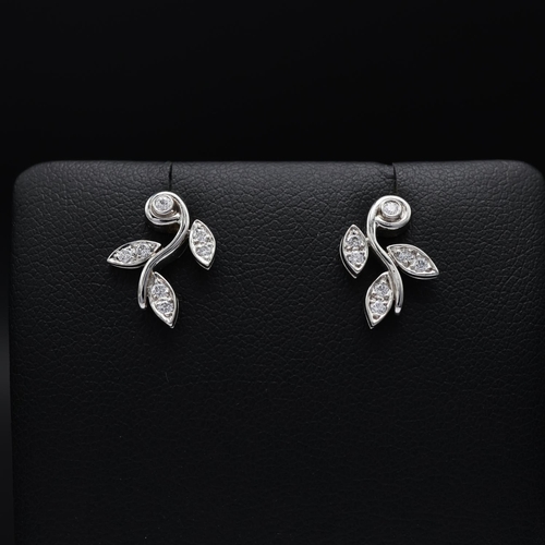 115 - A TIFFANY PAIR OF PLATINUM DIAMOND SET EARRINGS, each in the form of foliage and set with seven roun... 