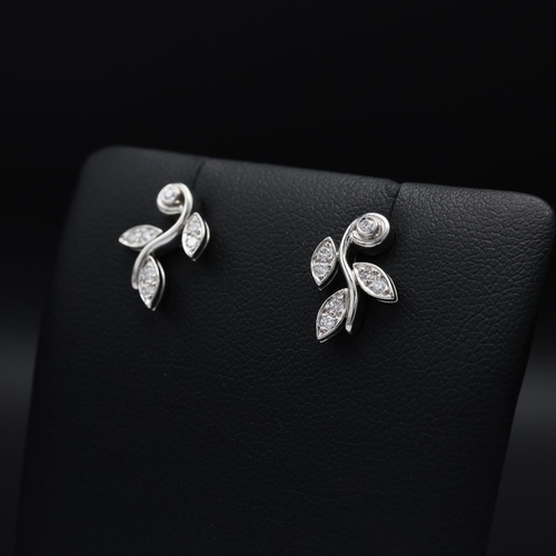 115 - A TIFFANY PAIR OF PLATINUM DIAMOND SET EARRINGS, each in the form of foliage and set with seven roun... 