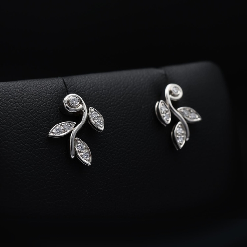 115 - A TIFFANY PAIR OF PLATINUM DIAMOND SET EARRINGS, each in the form of foliage and set with seven roun... 