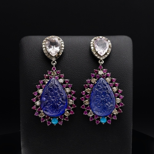 131 - A PAIR OF 14CT GOLD TANZANITE SET PENDANT EARRINGS, the carved tanzanite stones surrounded by turquo... 