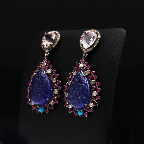 131 - A PAIR OF 14CT GOLD TANZANITE SET PENDANT EARRINGS, the carved tanzanite stones surrounded by turquo... 