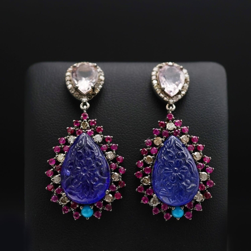 131 - A PAIR OF 14CT GOLD TANZANITE SET PENDANT EARRINGS, the carved tanzanite stones surrounded by turquo... 