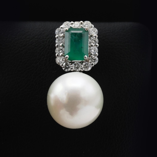 132 - A PAIR OF 18CT WHITE GOLD PEARL DROP EARRINGS, each set with a large emerald-cut emerald surrounded ... 