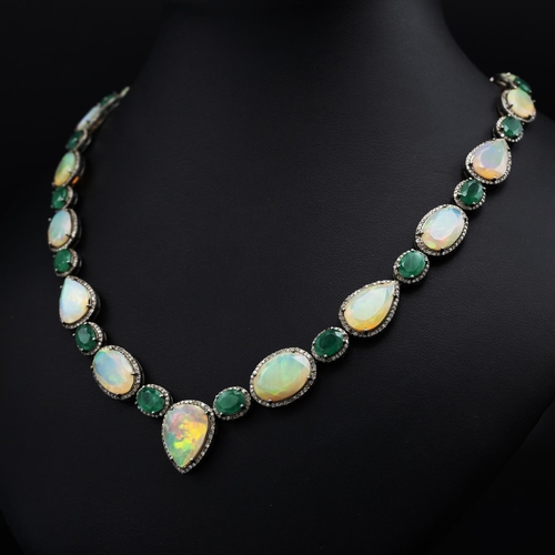 139 - Silver necklace set with faceted oval and pear-shaped opals, oval emeralds and rose-cut diamonds, in... 