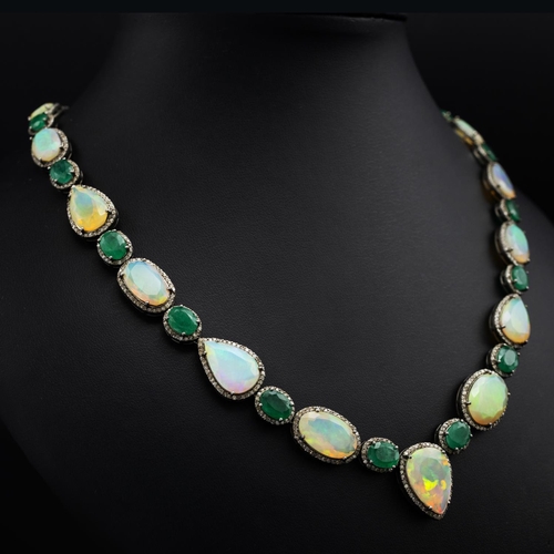 139 - Silver necklace set with faceted oval and pear-shaped opals, oval emeralds and rose-cut diamonds, in... 