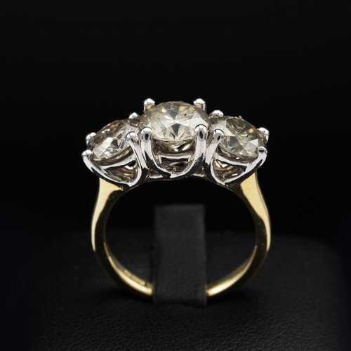 143 - AN 18CT GOLD DIAMOND TRILOGY RING, the white gold open backed setting with three claw set round bril... 