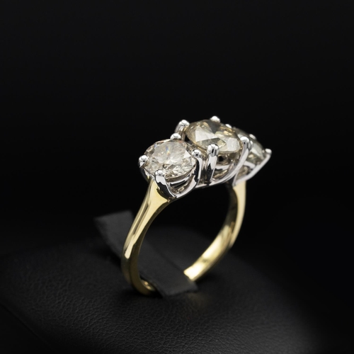 143 - AN 18CT GOLD DIAMOND TRILOGY RING, the white gold open backed setting with three claw set round bril... 