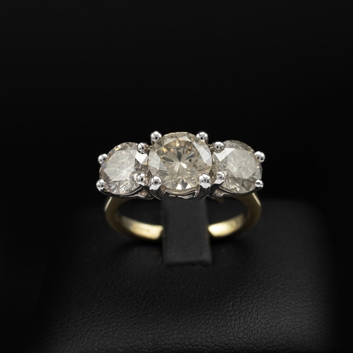 143 - AN 18CT GOLD DIAMOND TRILOGY RING, the white gold open backed setting with three claw set round bril... 